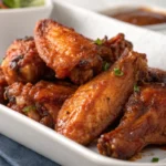Crispy baked chicken wings coated in sticky barbecue sauce