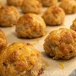 Close-up of juicy sausage balls baked without Bisquick on a parchment-lined tray.