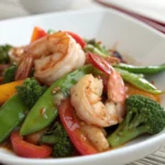 High protein meal prep container with salmon, asparagus, and rice.